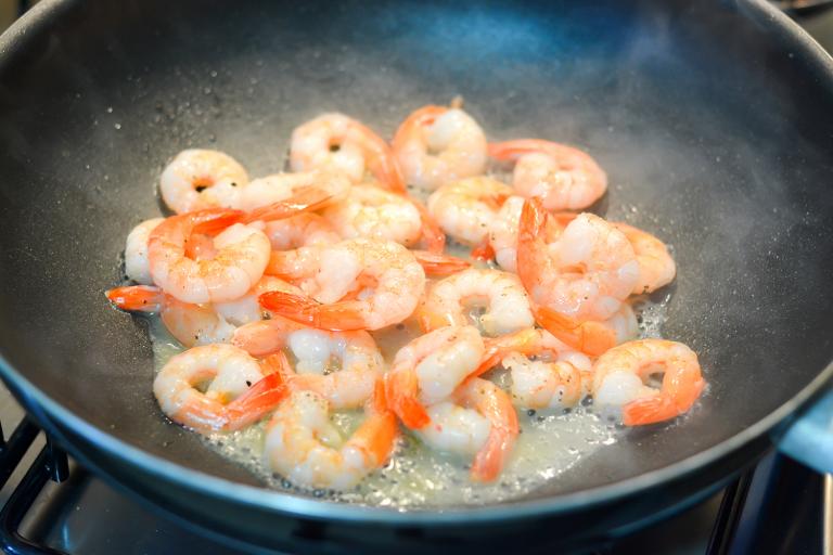 deveined shrimp frying in a hot wok